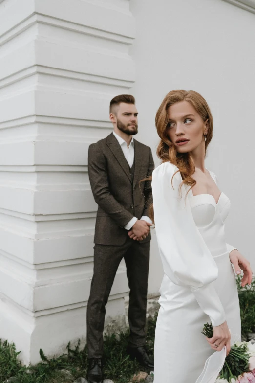 man and woman dressed in business suits standing together