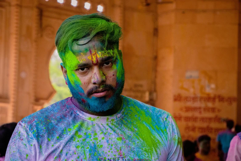 man with his hair dyed green and purple