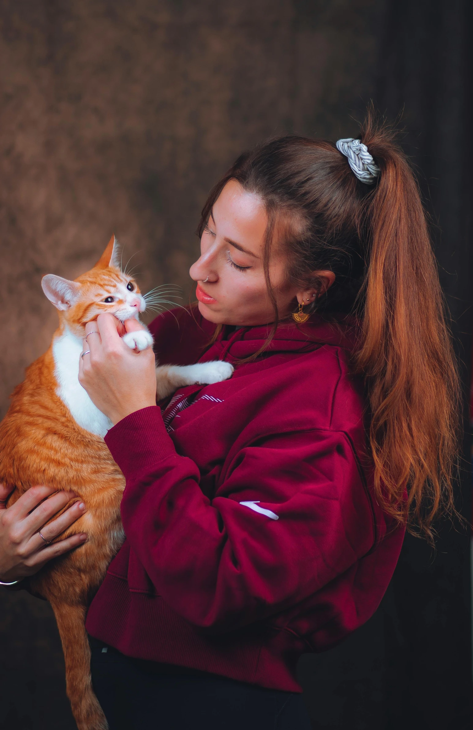 a woman is holding a cat in her arms