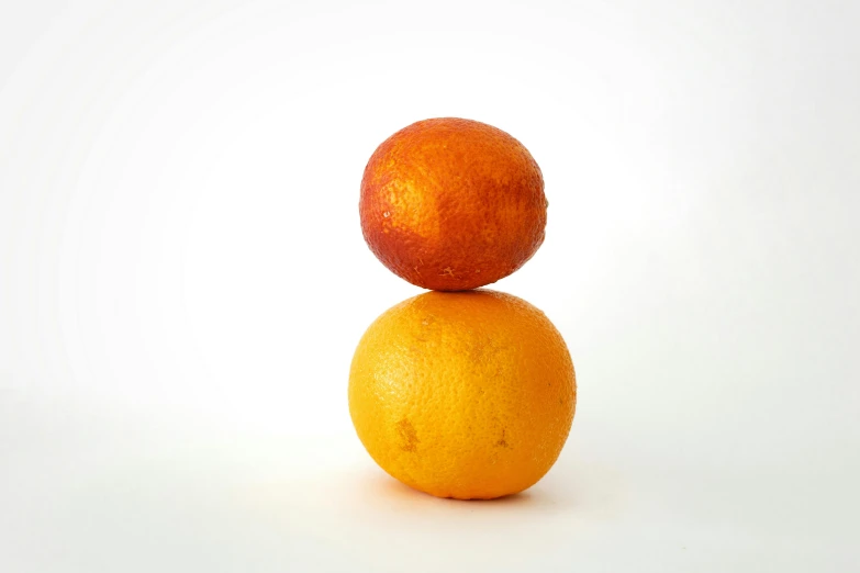 two oranges stacked on top of each other