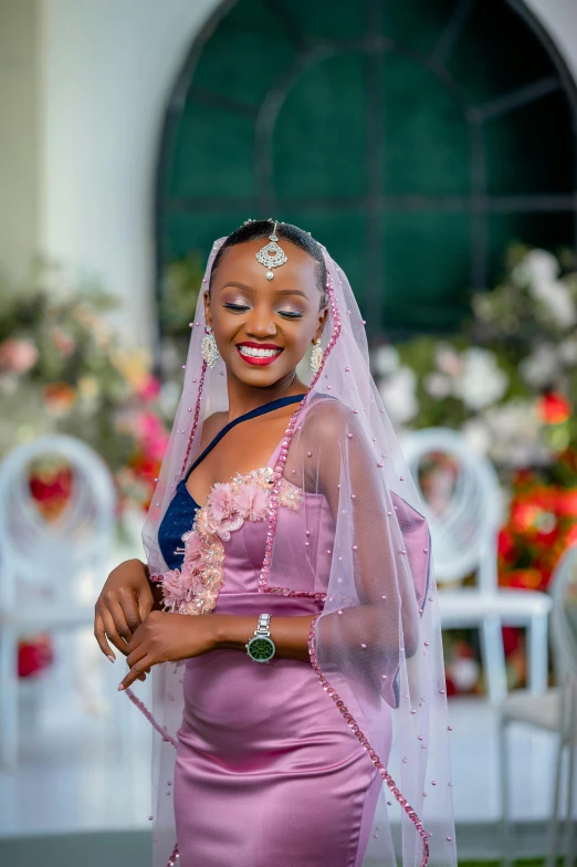 the beautiful african woman is smiling while posing for the camera