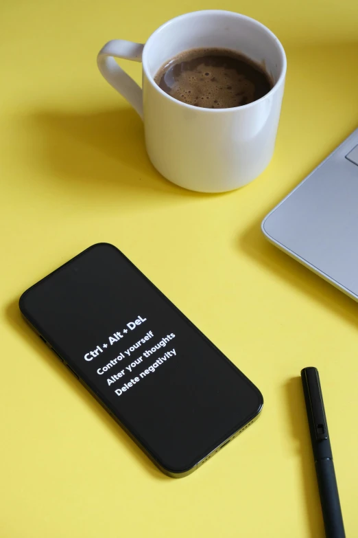 the coffee mug is sitting next to the notebook on the table