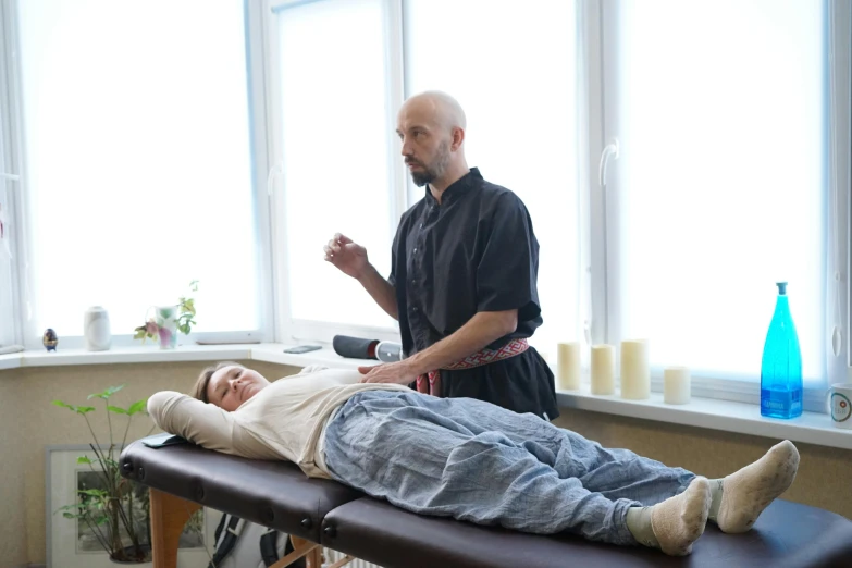 a man receiving a massage from a physcleme