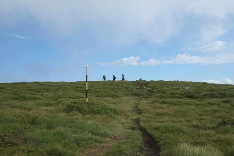 the men are on the top of a mountain