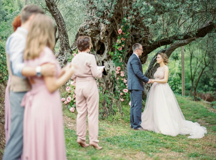 an outdoor wedding ceremony with a couple walking away