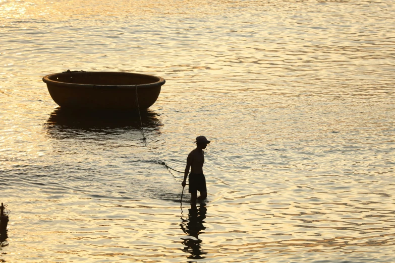 a boy stands on top of a boat in water