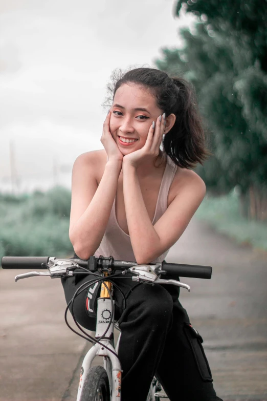 a woman is talking on the phone while riding a bike