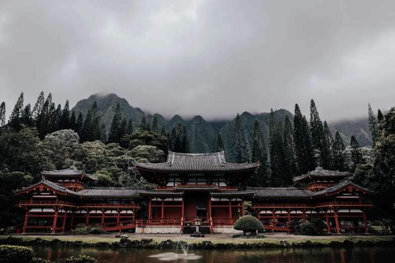 a large red building is in front of trees