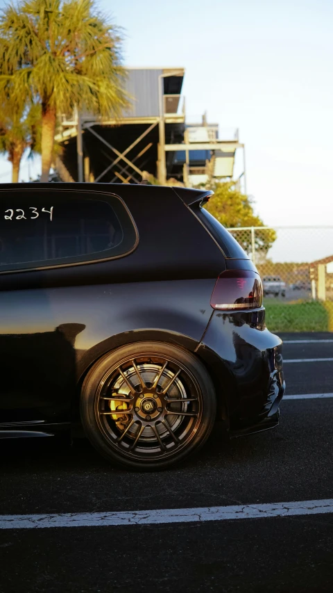 a black car with a large rear end painted on it