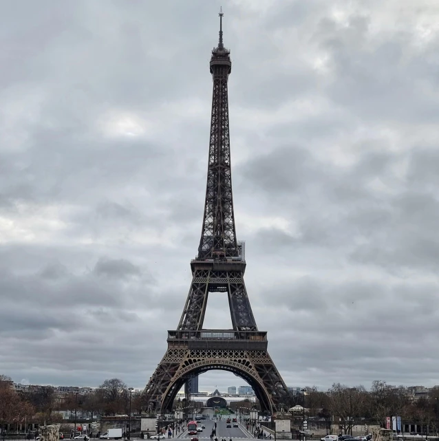 a very tall building with a tower near a crowd of people