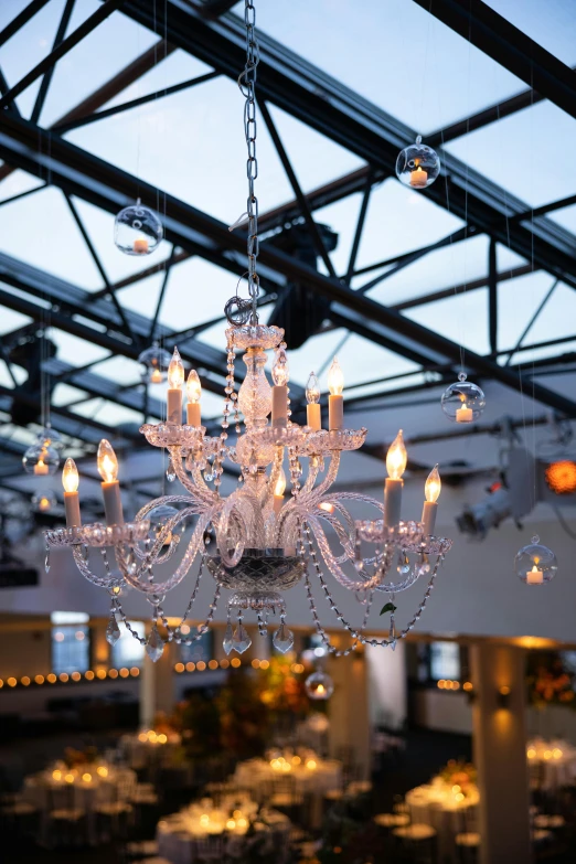 a chandelier hanging from the ceiling inside of a building