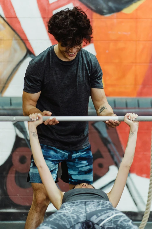 the two young men are doing pull ups on their hands