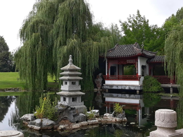 chinese pavilion in the park next to the water