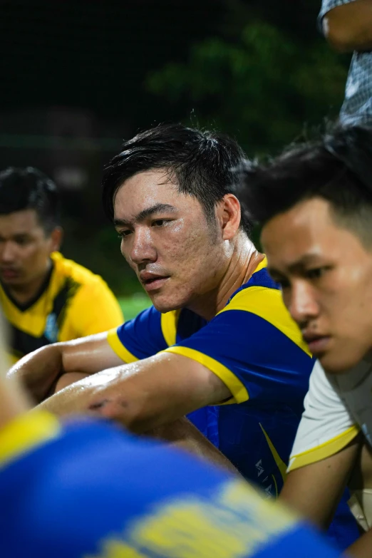 a group of men are in a team with the man with black hair