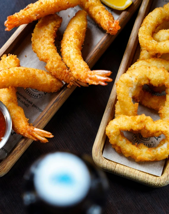 shrimp rings on trays and small bowl of sauce