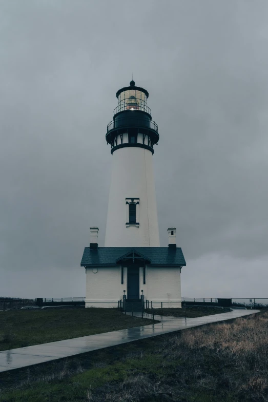 the lighthouse is on a wet gray day