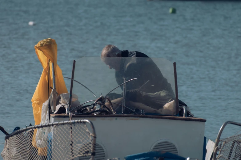 there is a man on a small boat in the water