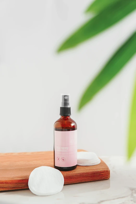 a bottle of lotion sitting on top of a wooden  board