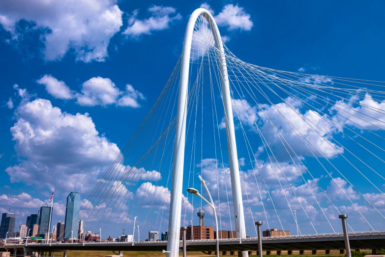 a blue and white tall bridge on a cloudy day