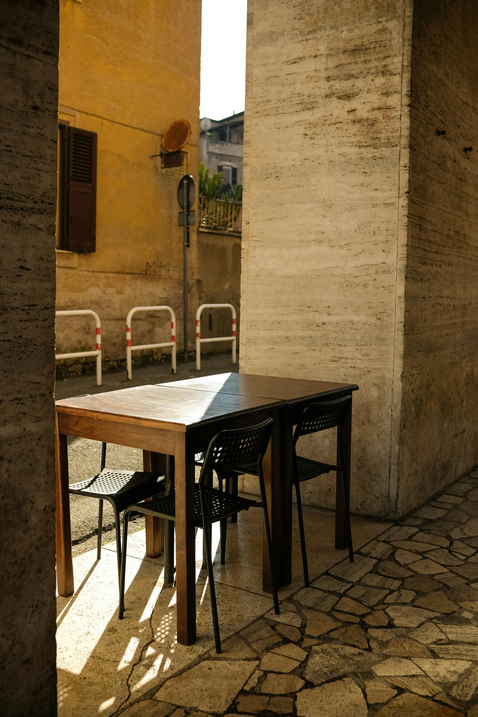 there is a table and chairs near a building