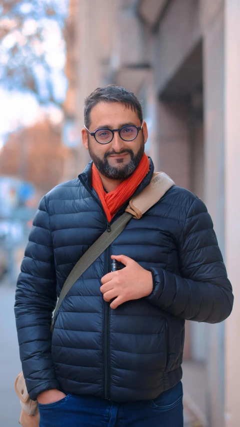 a man is standing in the street while holding onto his hand