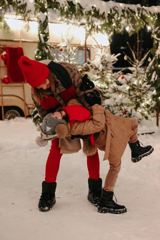 a person is carrying a child in a bag in the snow