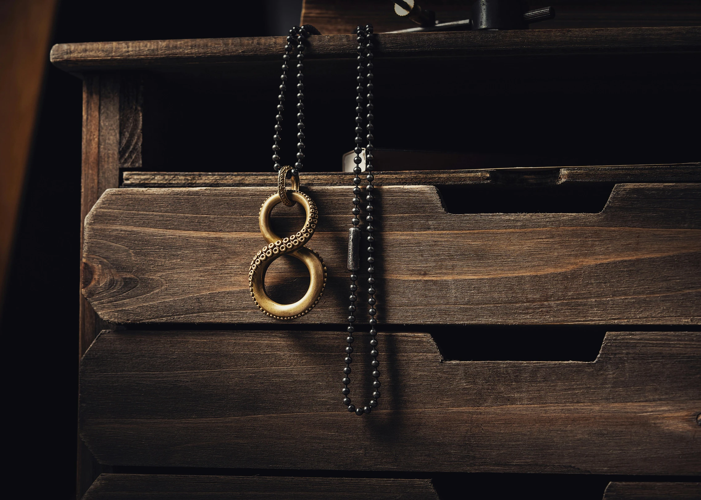 this is an image of a wooden box with two rings