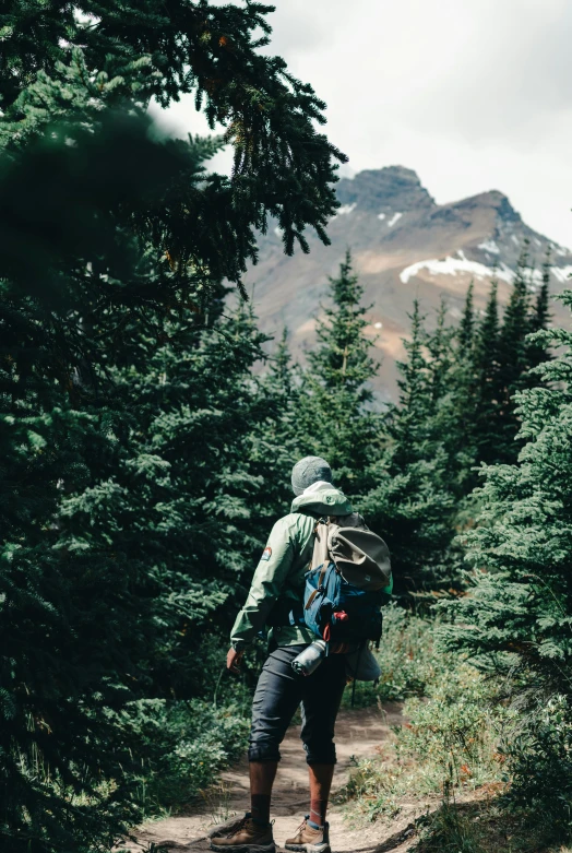 a person wearing hiking gear is walking along a path