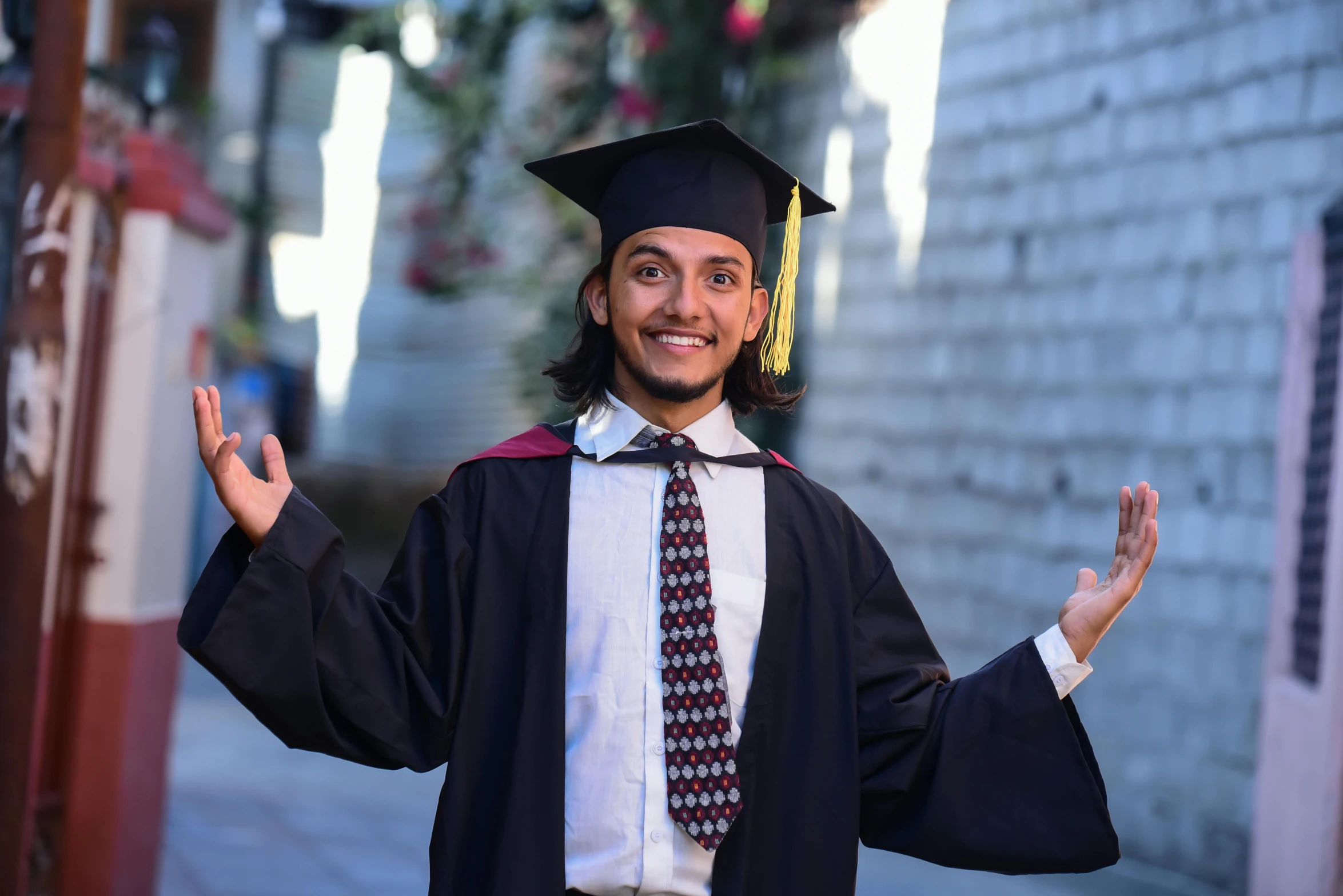 a man is wearing a graduation gown and hat