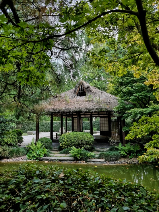 the gazebo is surrounded by the greenery and in bloom