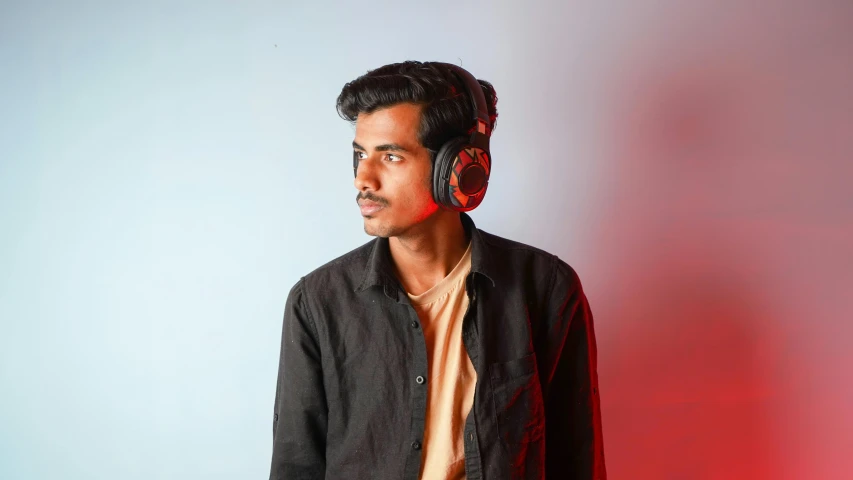 a man standing with a headphone on his face