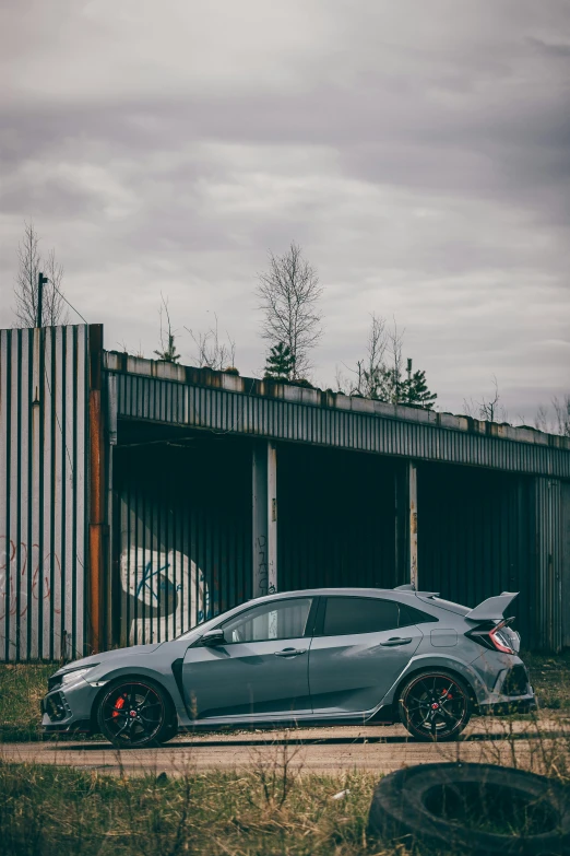 a gray sport car parked on the side of the road