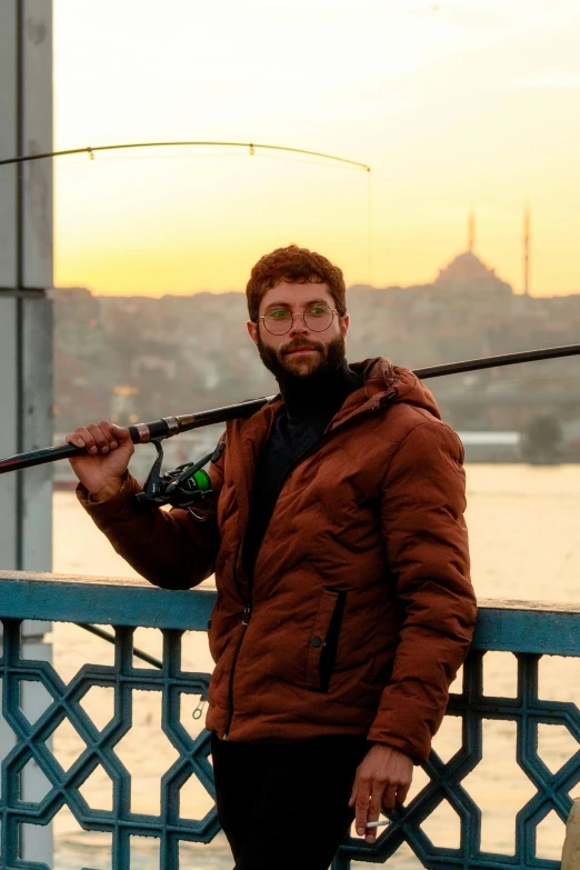a man with a beard holding up a fishing rod