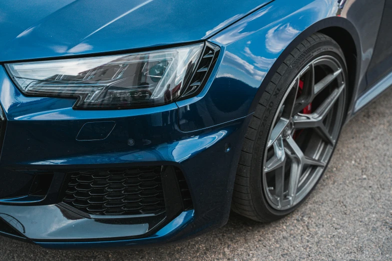 a blue car that is sitting in the road