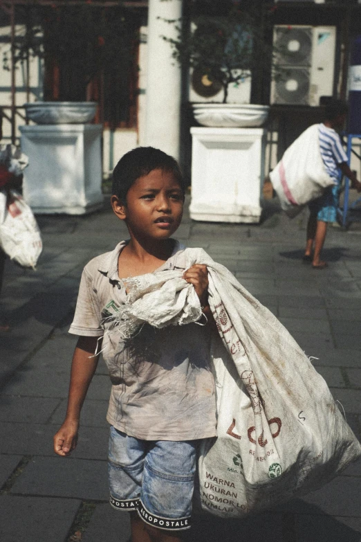 a  is carrying some sand bags