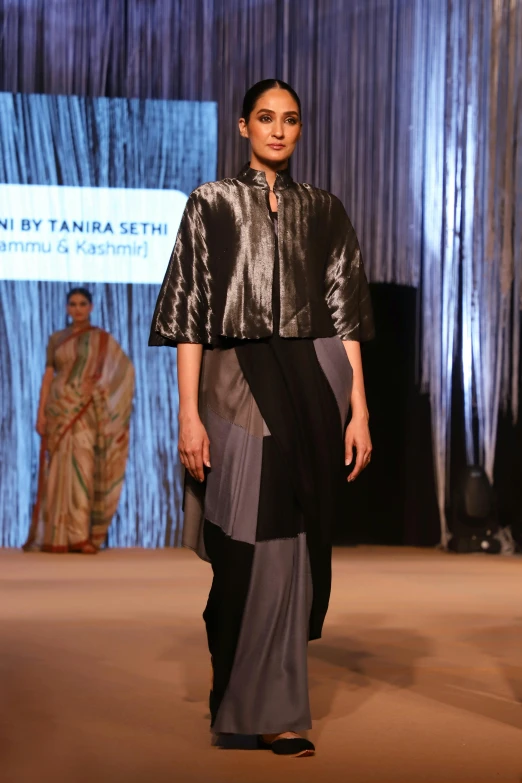 a woman on the catwalk at a fashion show