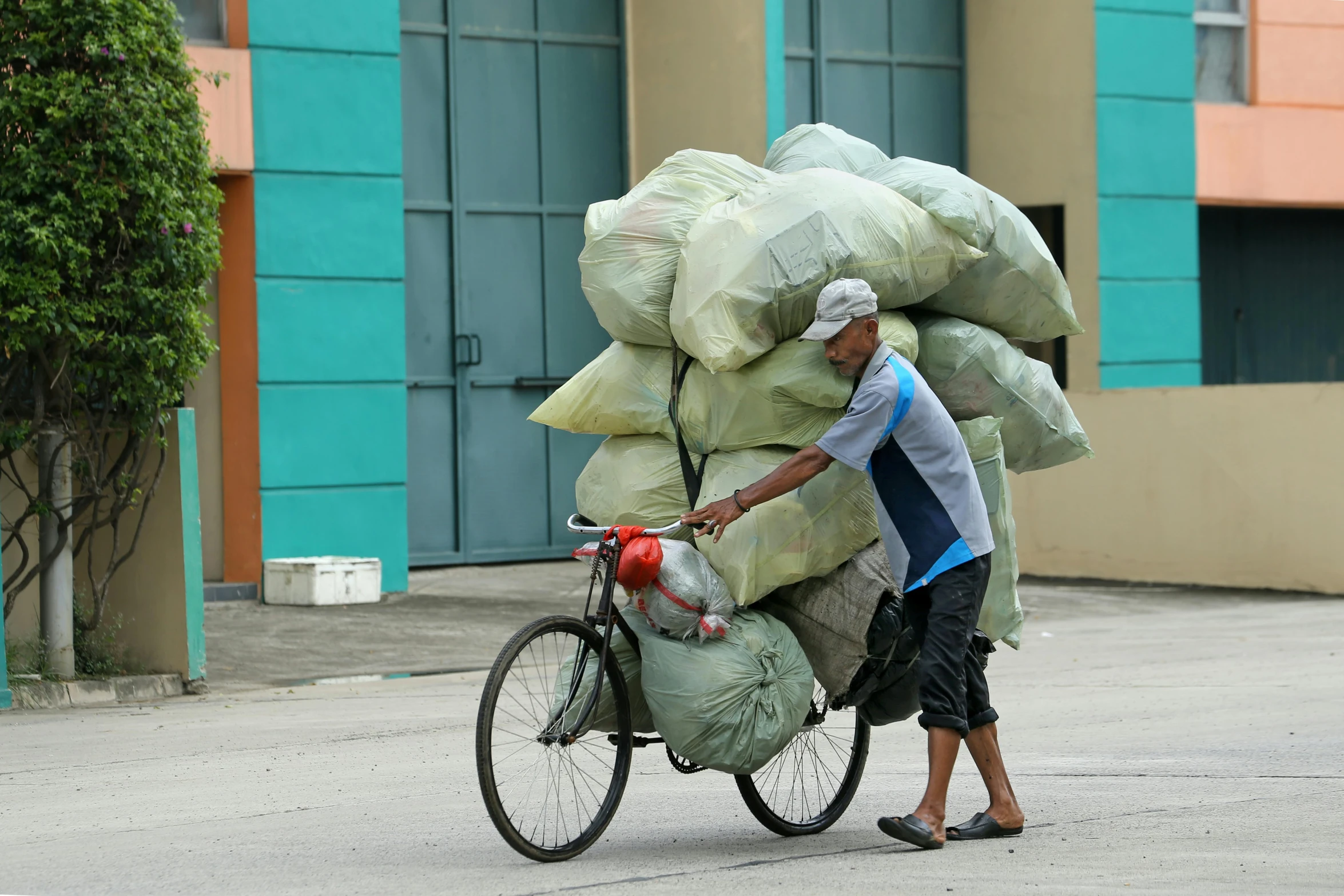 a person on a bike loaded with bags