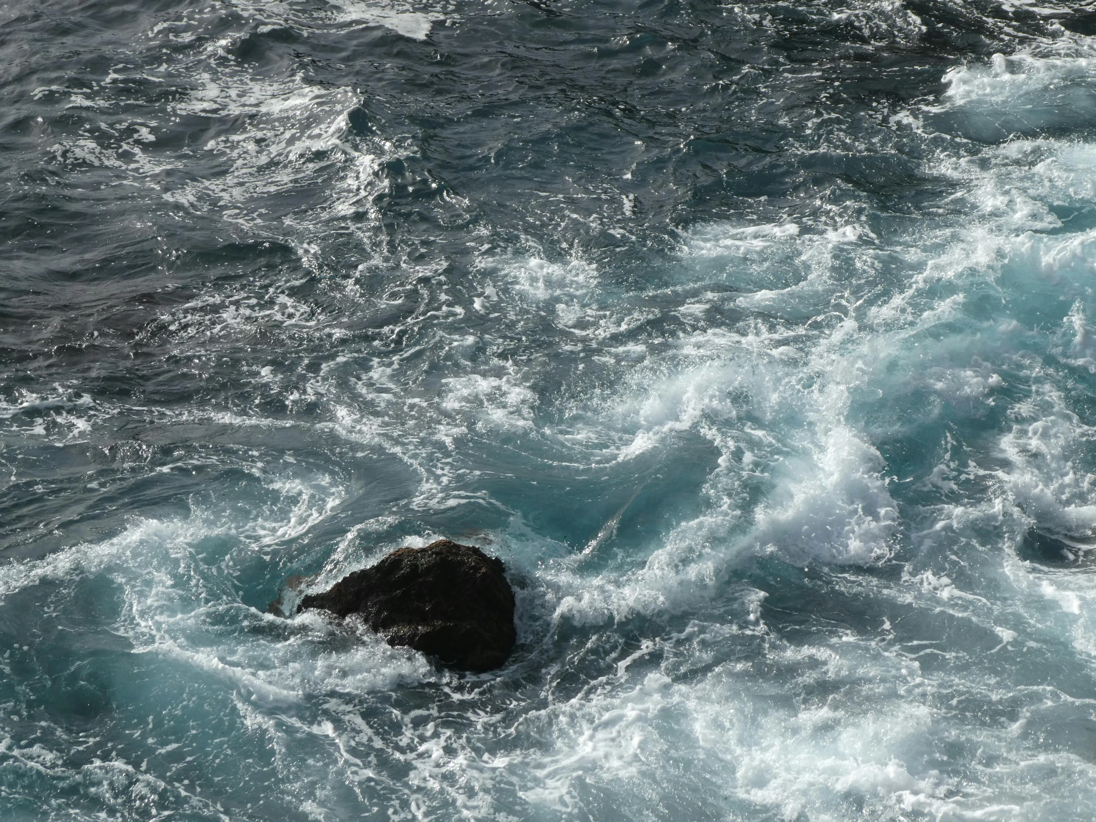 a person is laying on their stomach in the water