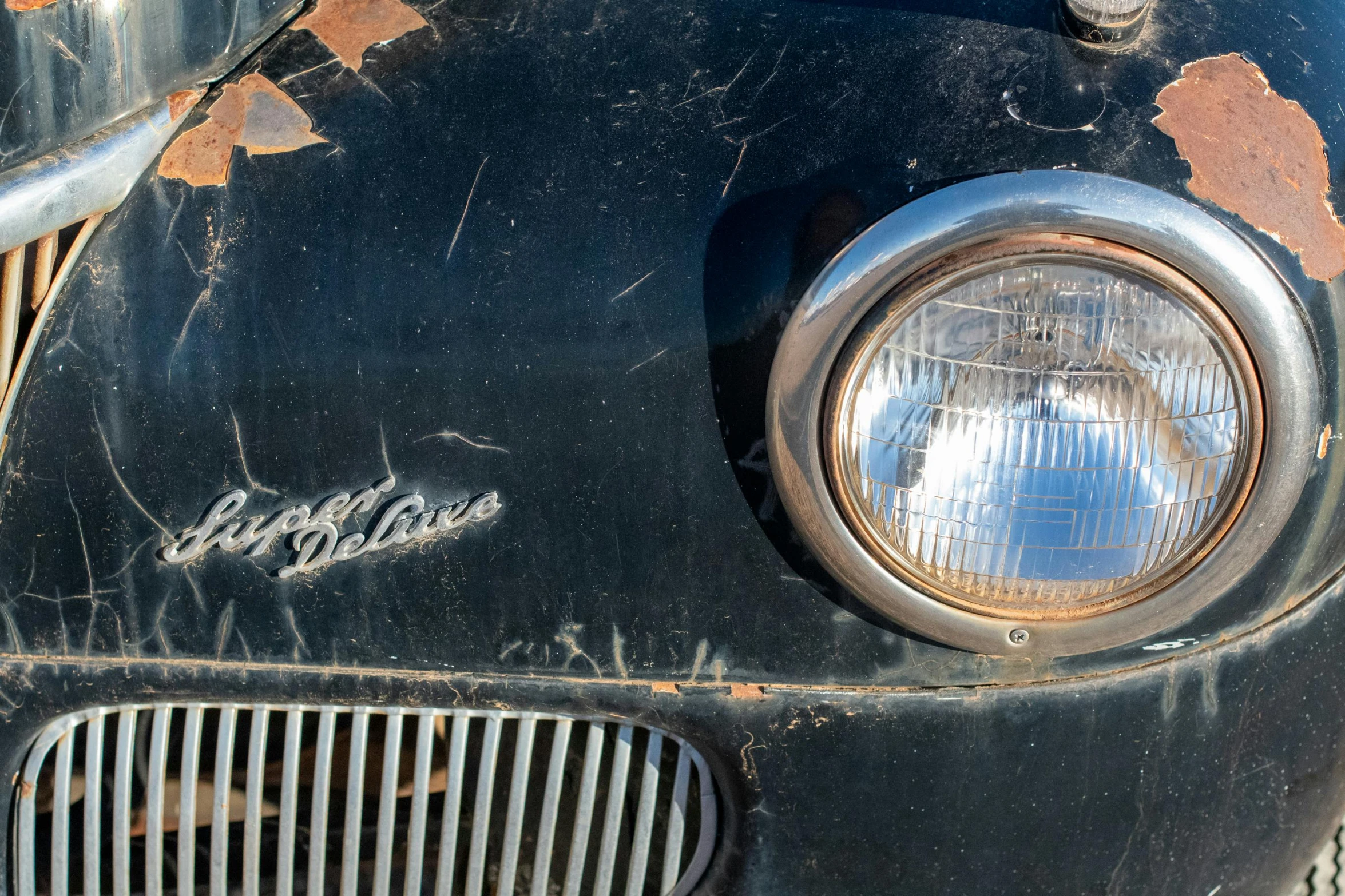 an old, rusted car that is sitting in the street