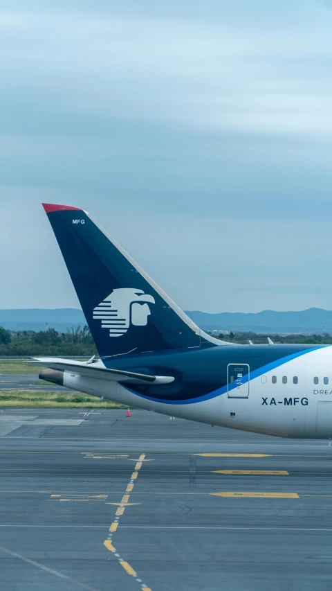 three white and blue airplanes parked on an airport