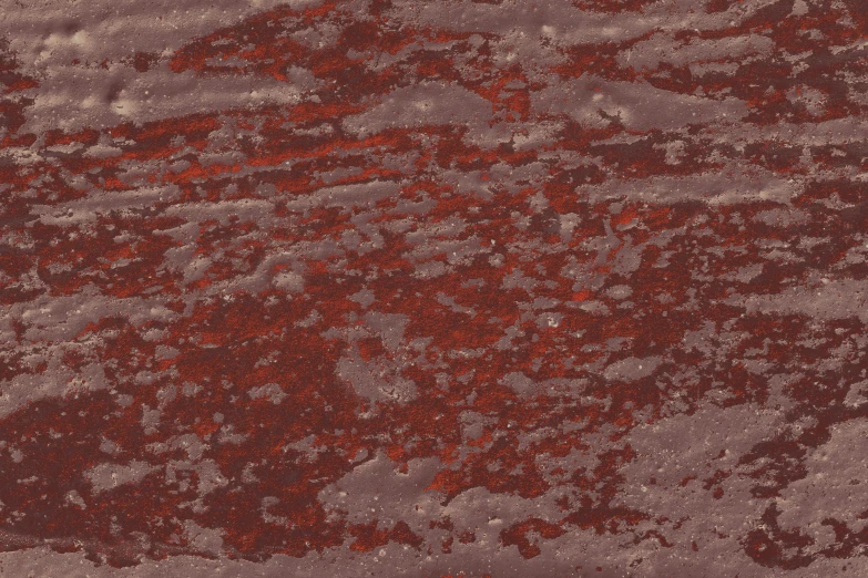 a bunch of red paint is mixed in with a very dark red background