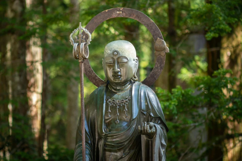 an intricate bronze buddha statue with a circular object