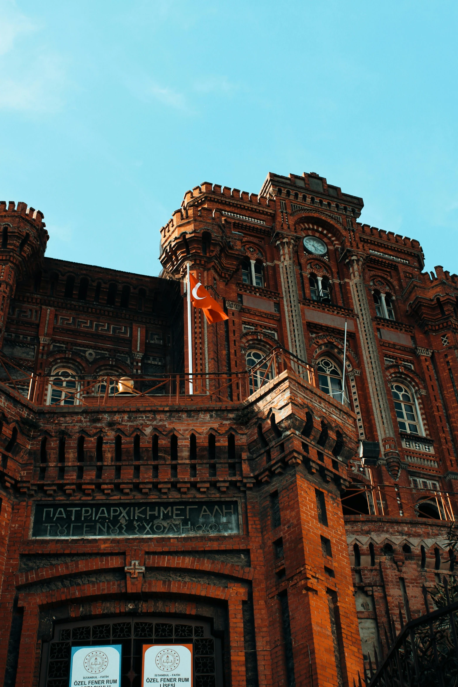 a large brick building with two clocks on the top