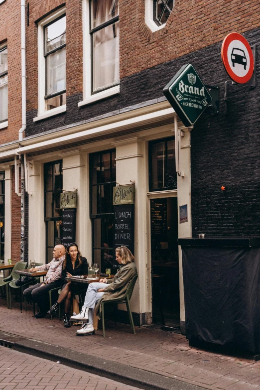 a group of people sitting at outdoor tables eating outside