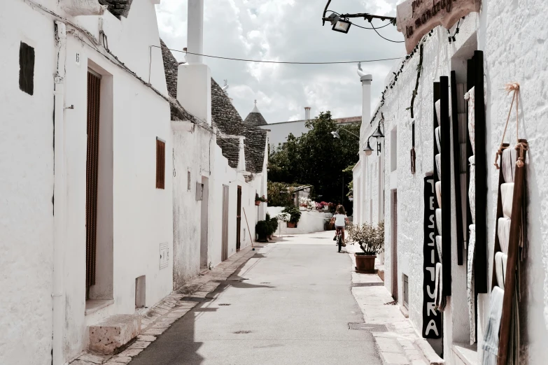 a cobblestone alley between two buildings on an overcast day