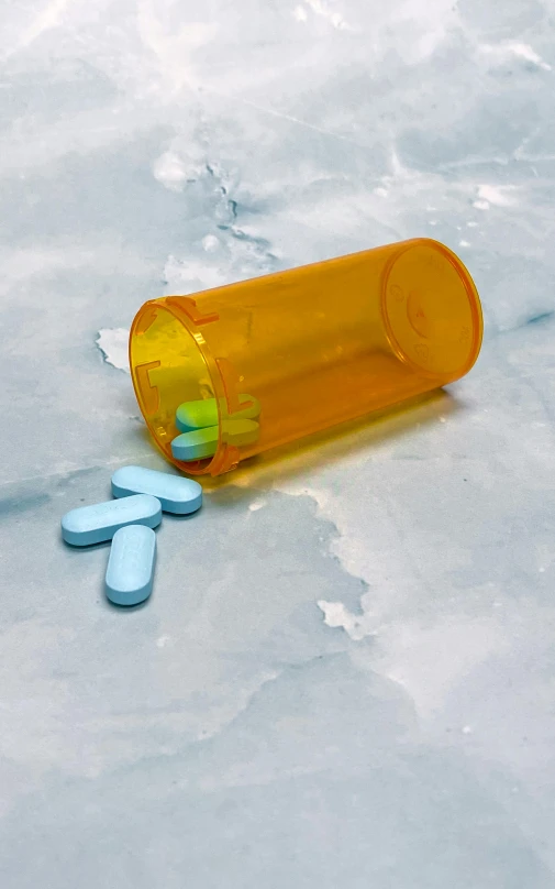 a bottle of pills sitting on top of ice