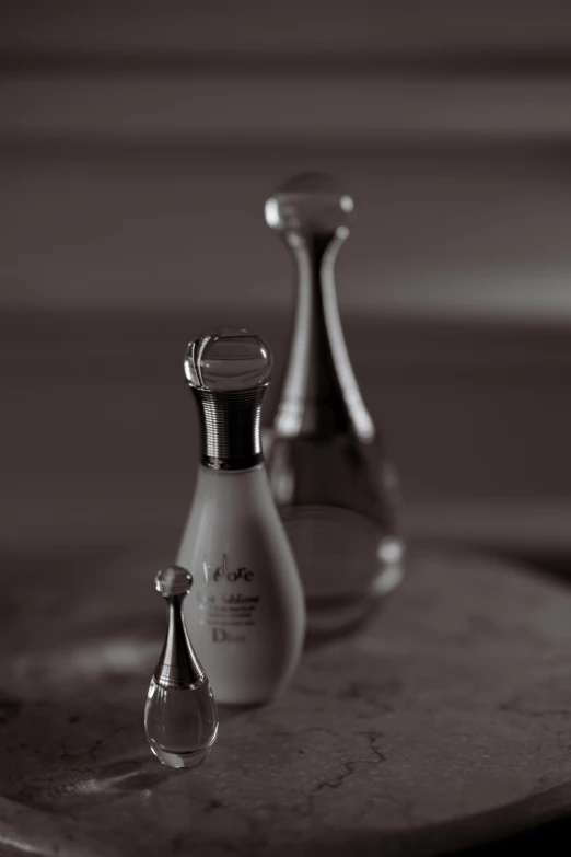 two bottles of perfume sitting on top of a table