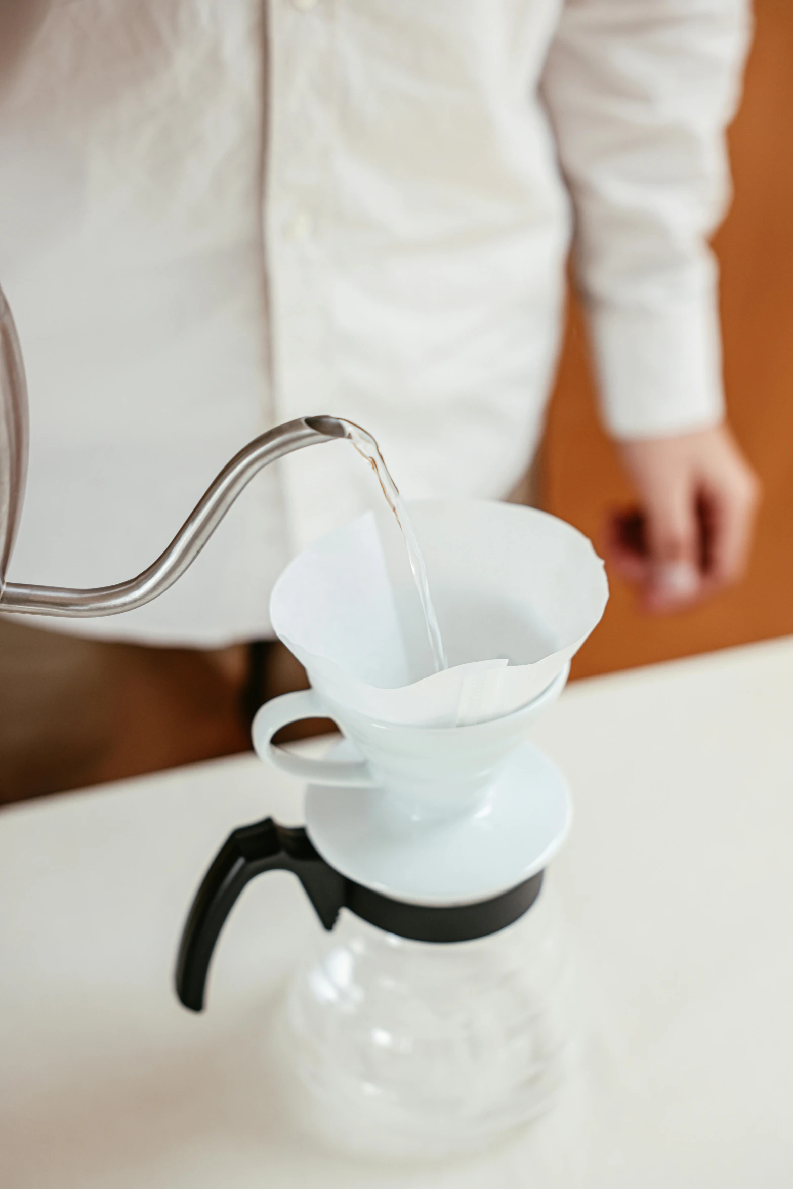 a pitcher of water being filtered from a faucet