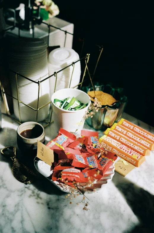 a cup of coffee and some candy on a counter