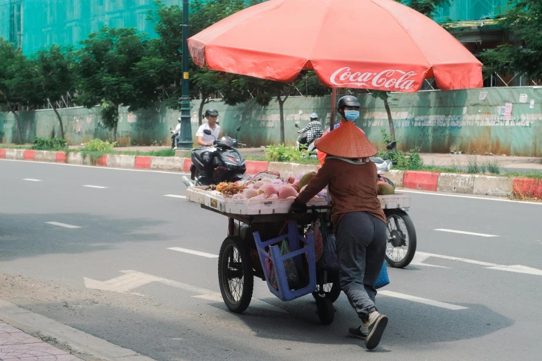 a man hing a cart behind it with a food tray